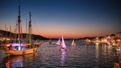 7th Night regatta of traditional sailing boats under the spotlights