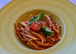 Traditional pljukanci pasta with shrimp and courgettes